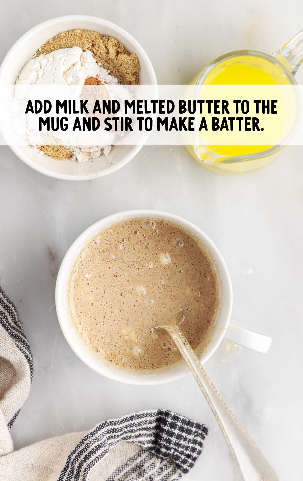 milk and butter added to the dry ingredient mixture in a mug