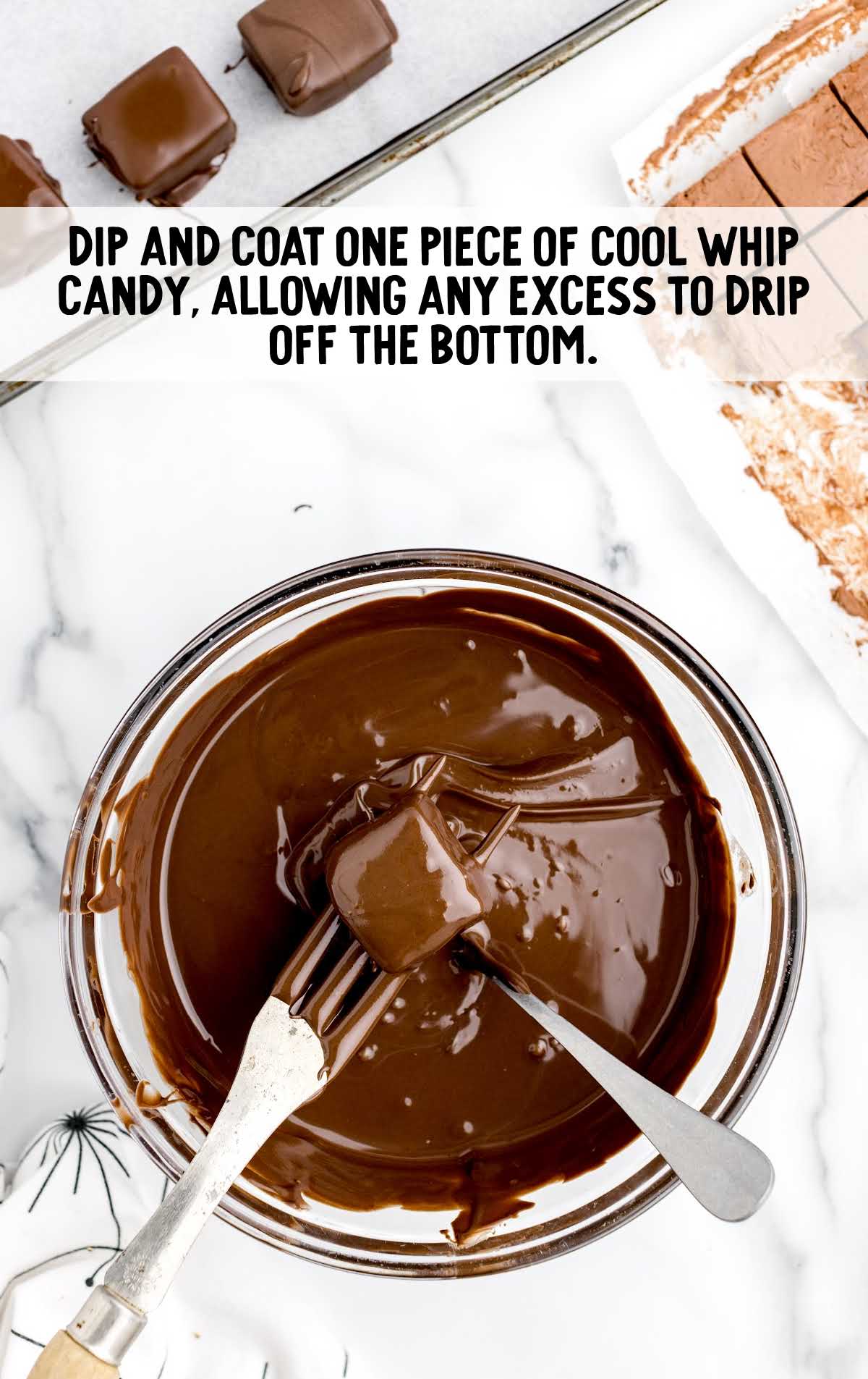cool whip candy dipped in a bowl of melted chocolate