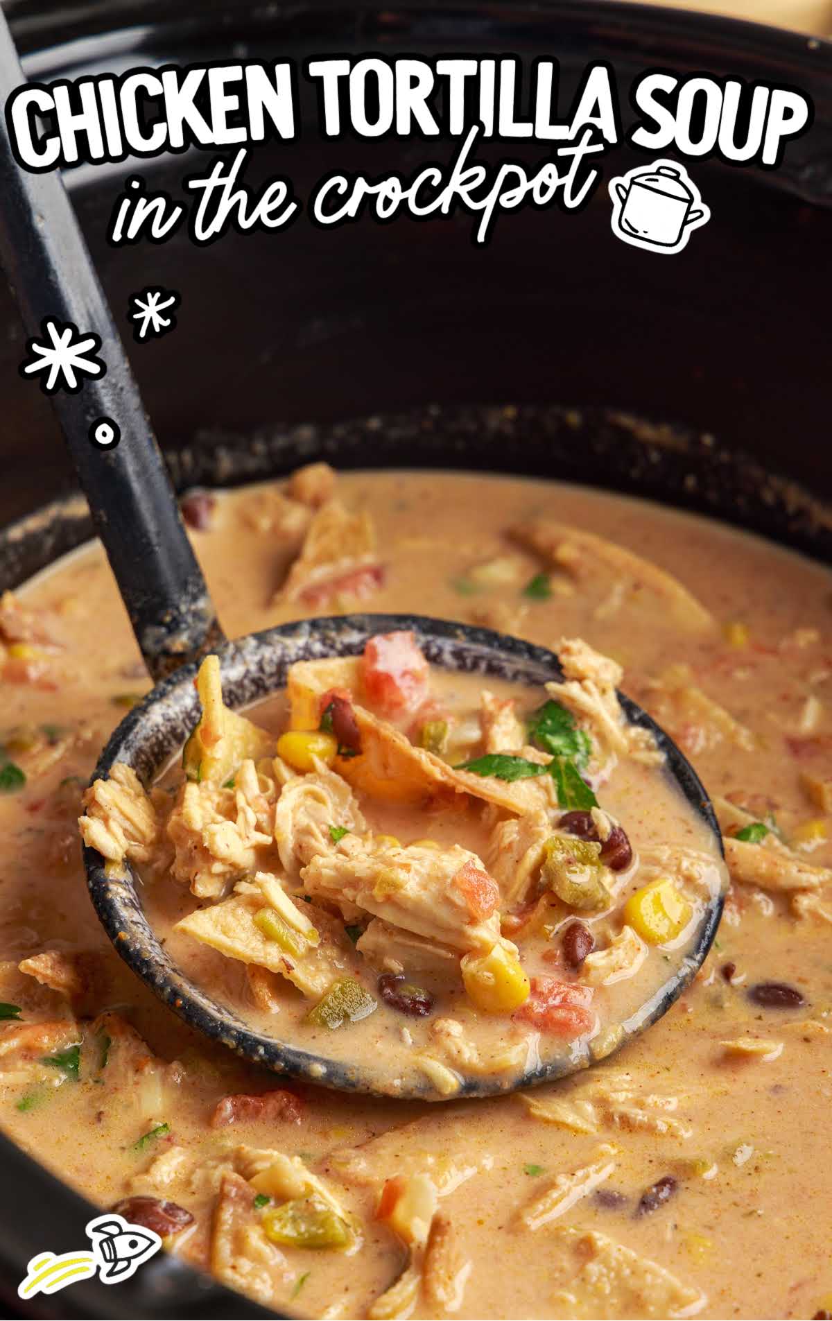a crockpot of chicken tortilla soup with a large soup spoon