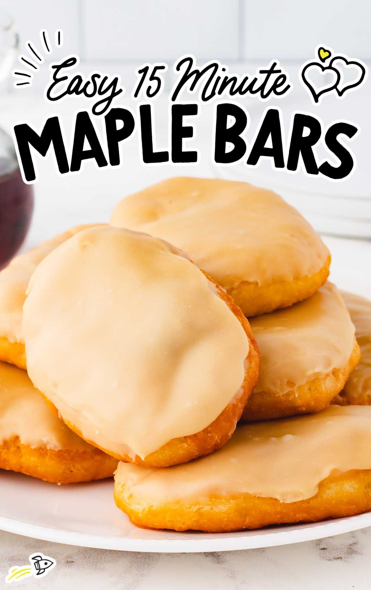 a close up shot of Maple Bars stacked on top of each other on a plate