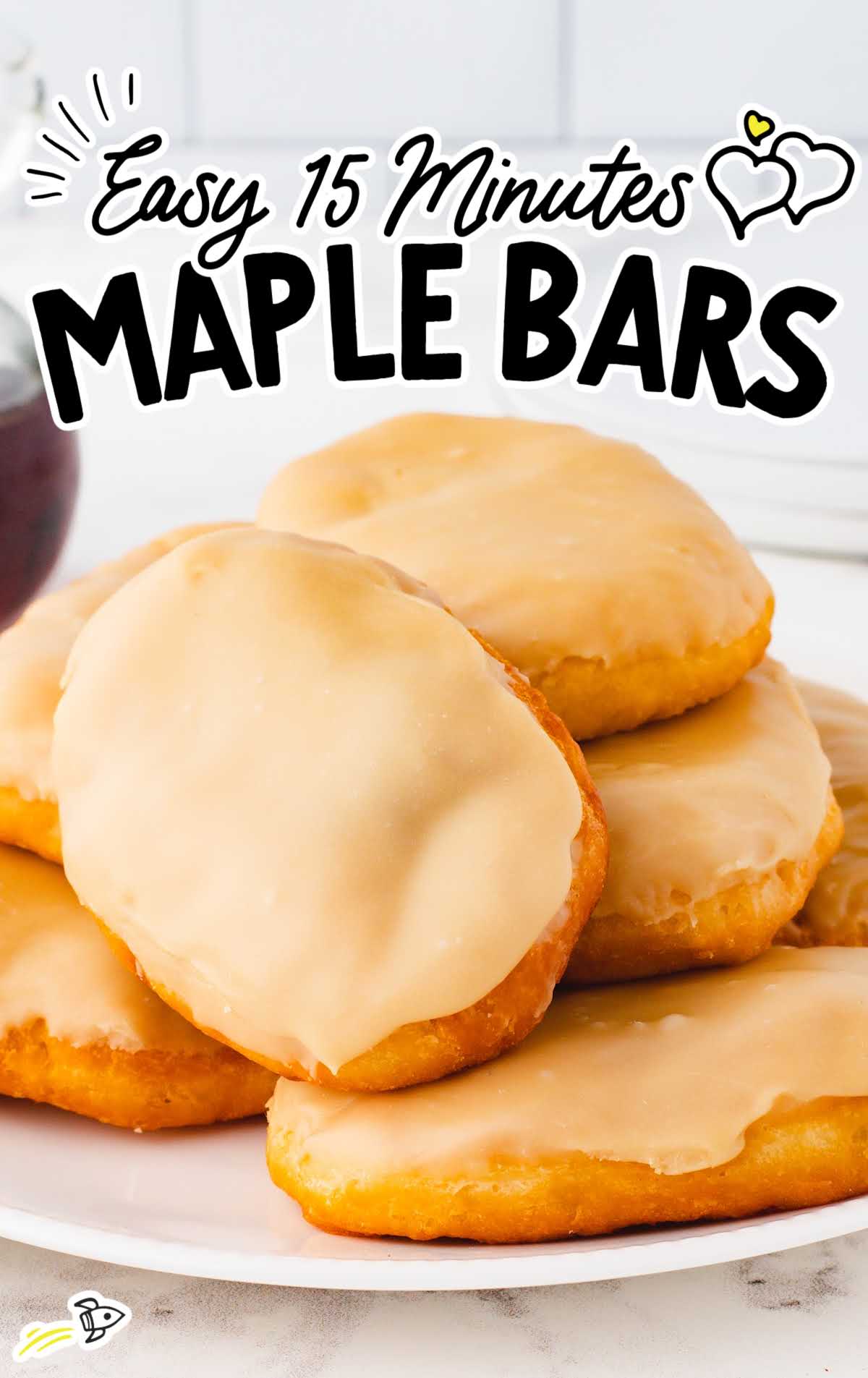 a close up shot of Easy 15-Minute Maple Bars stacked on top of each other on a plate