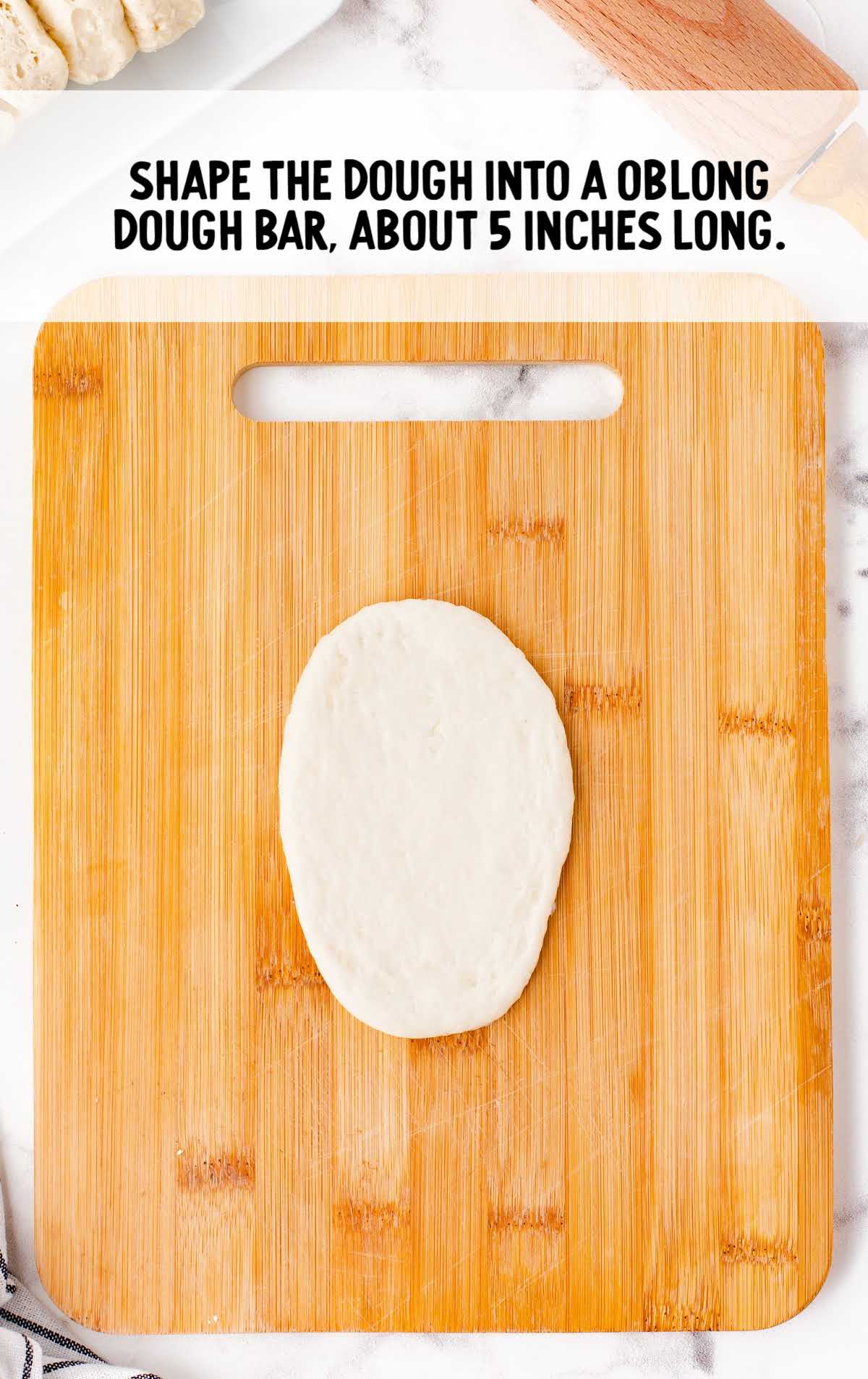 dough shaped into a oblong bar on a cutting board