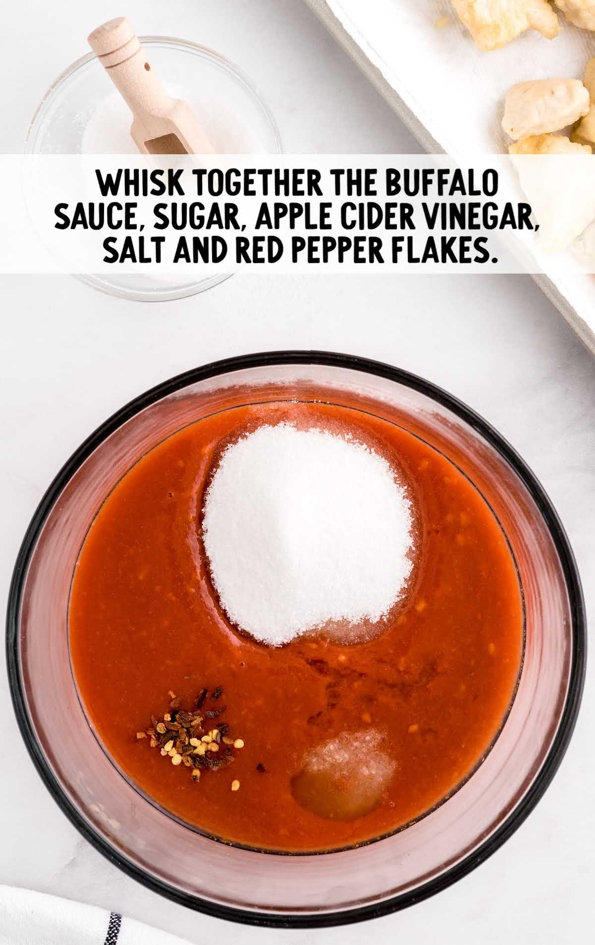 buffalo sauce, sugar, apple cider vinegar, salt and red pepper flakes whisked in a bowl