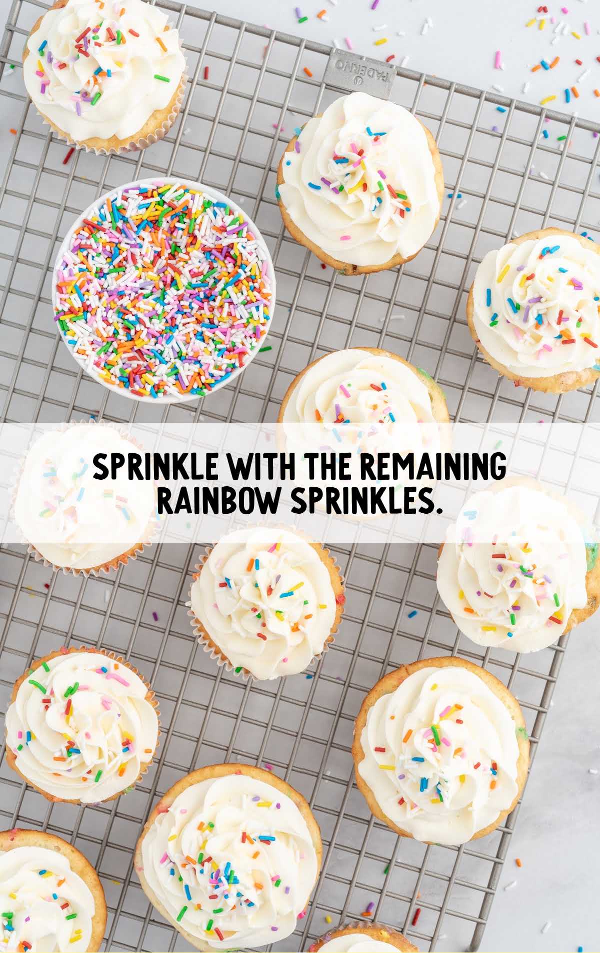 rainbow sprinkles sprinkled on top of the cupcakes