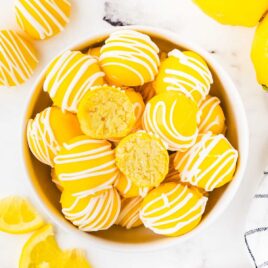 overhead shot of Lemon Cheesecake Bites in a bowl with one split in half