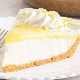 a close up shot of a slice of Lemon Cream Cheese Pie on a plate