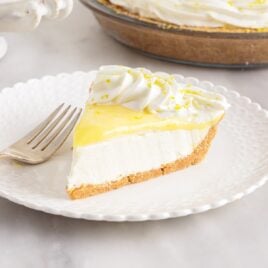 a close up shot of a slice of Lemon Cream Cheese Pie on a plate
