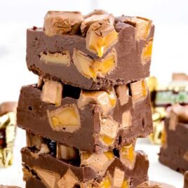 a close up shot of pieces of Milky Way Fudge stacked on top of each other