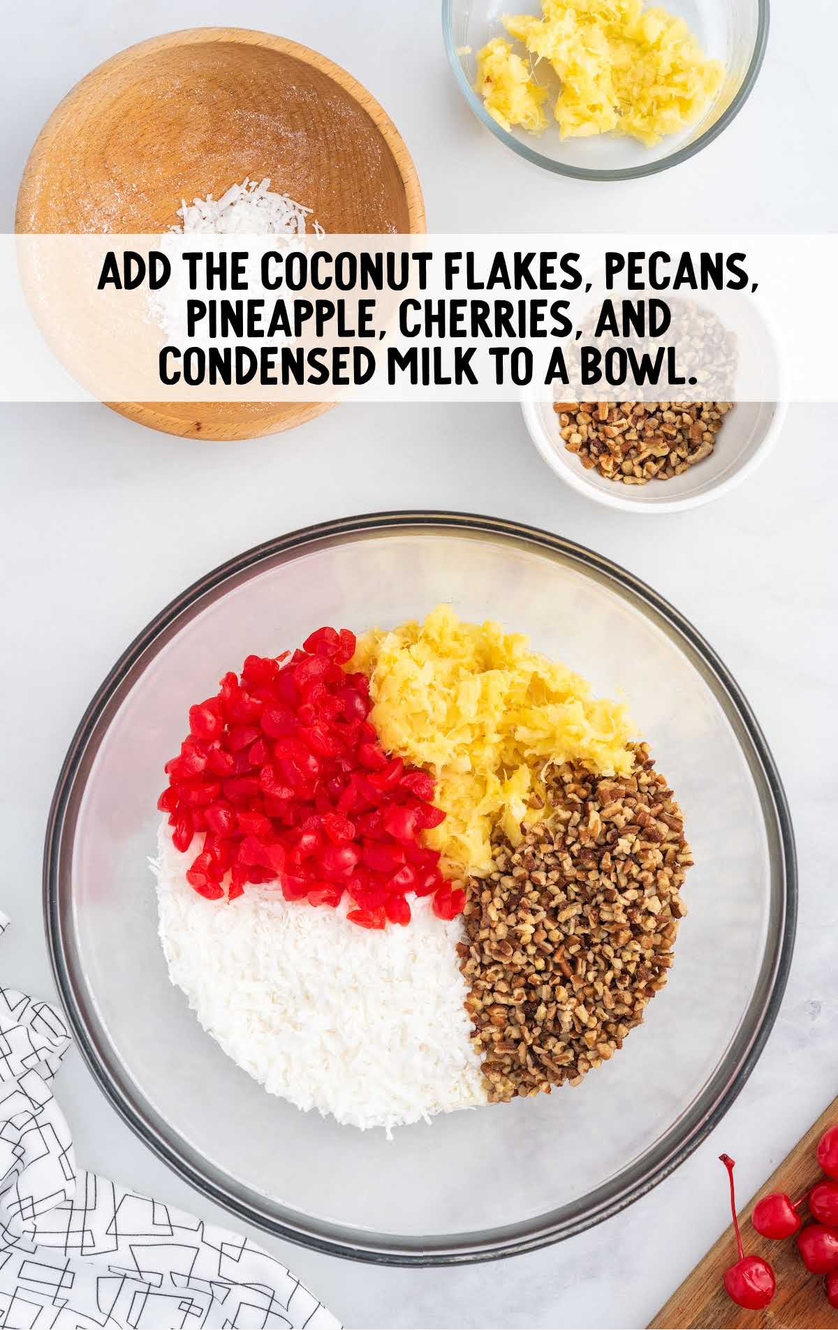 coconut flakes, pecans, pineapple, cherries, and condensed milk combined in a bowl