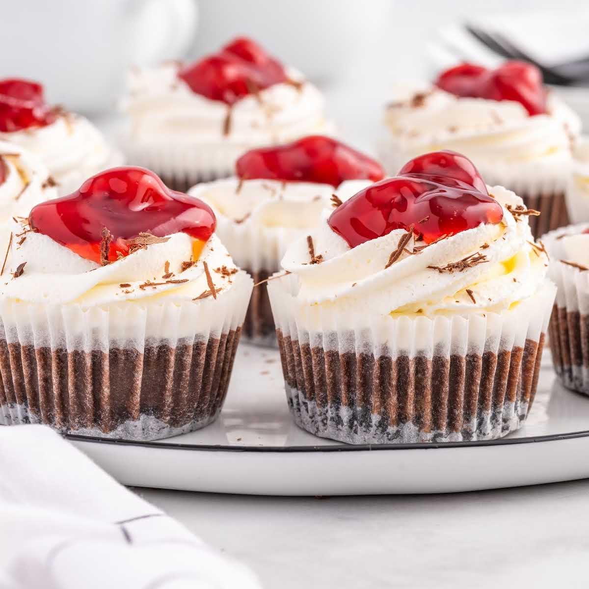a close up shot of Mini Black Forest Cheesecakes on a platter