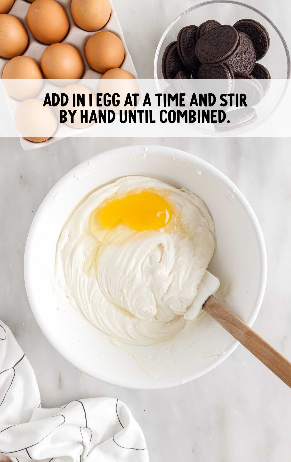 eggs folded into the cream cheese mixture in a bowl