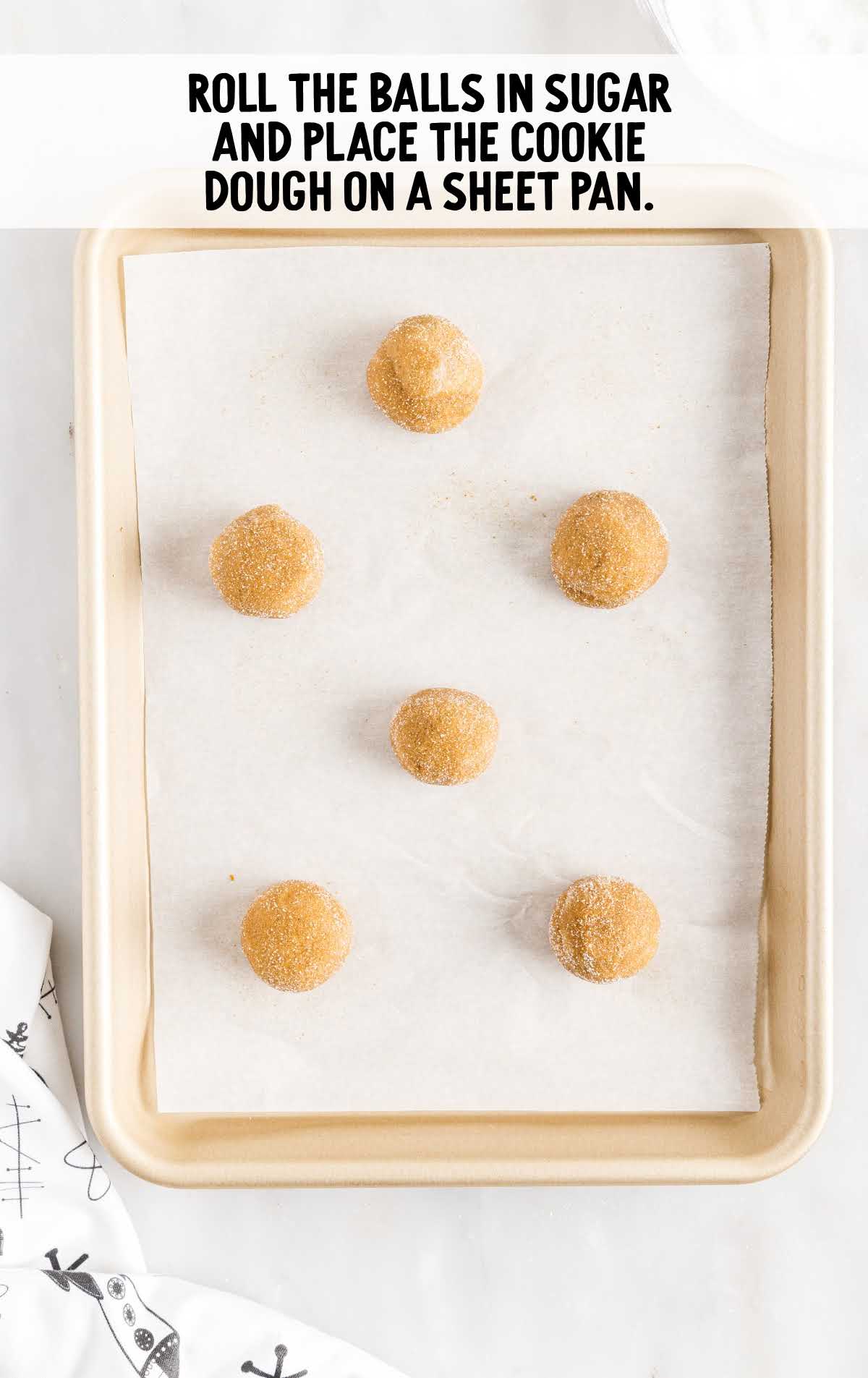 ball rolled in sugar and placed in a sheet pan