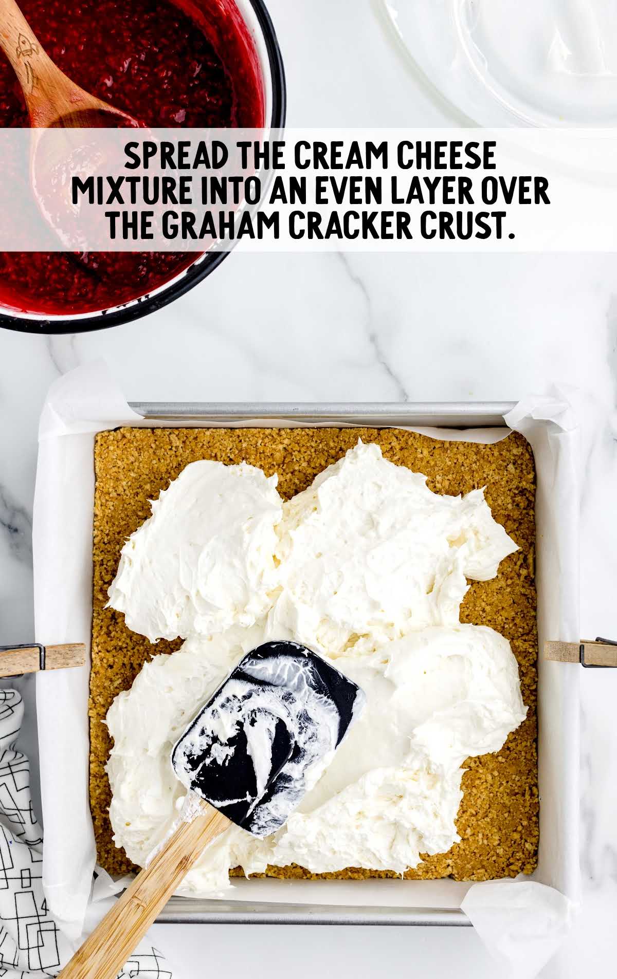 cream cheese mixture spread into the even layer over the graham cracker crust in a baking dish
