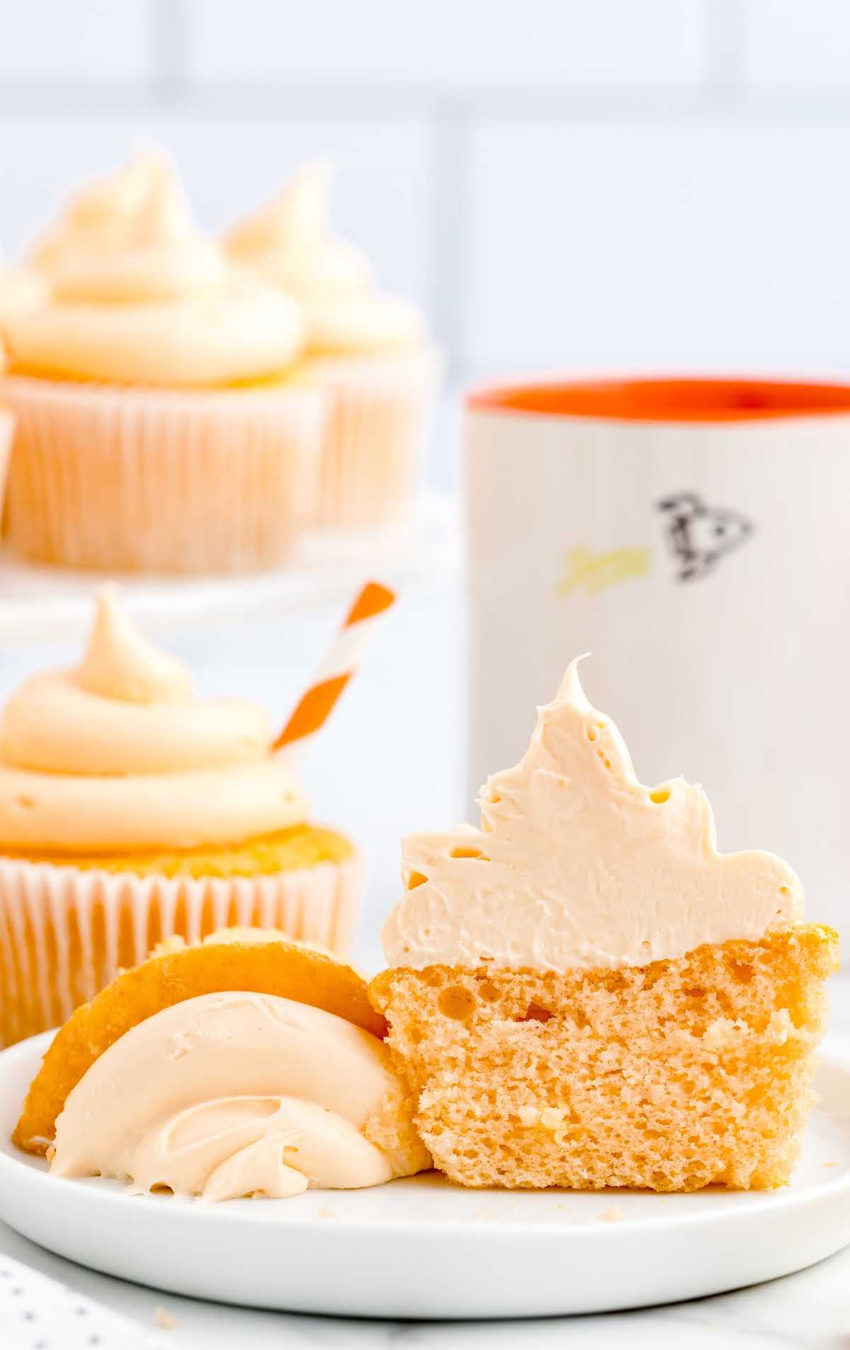 close up shot of Orange Creamsicle Cupcakes split in half on a plate