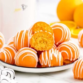 a close up shot of Orange Truffles on a plate with one split in half