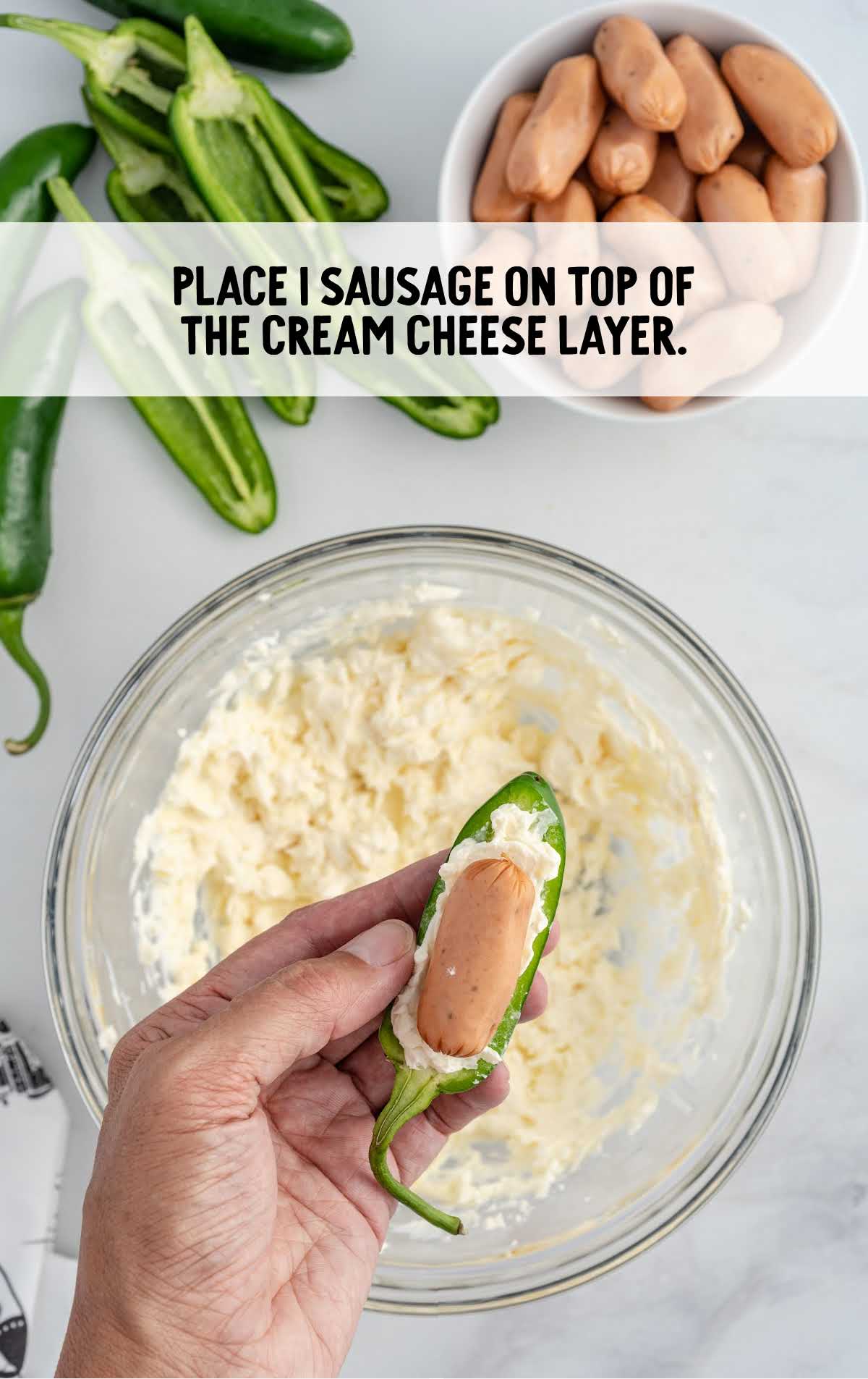 sausage placed on top of the cream cheese