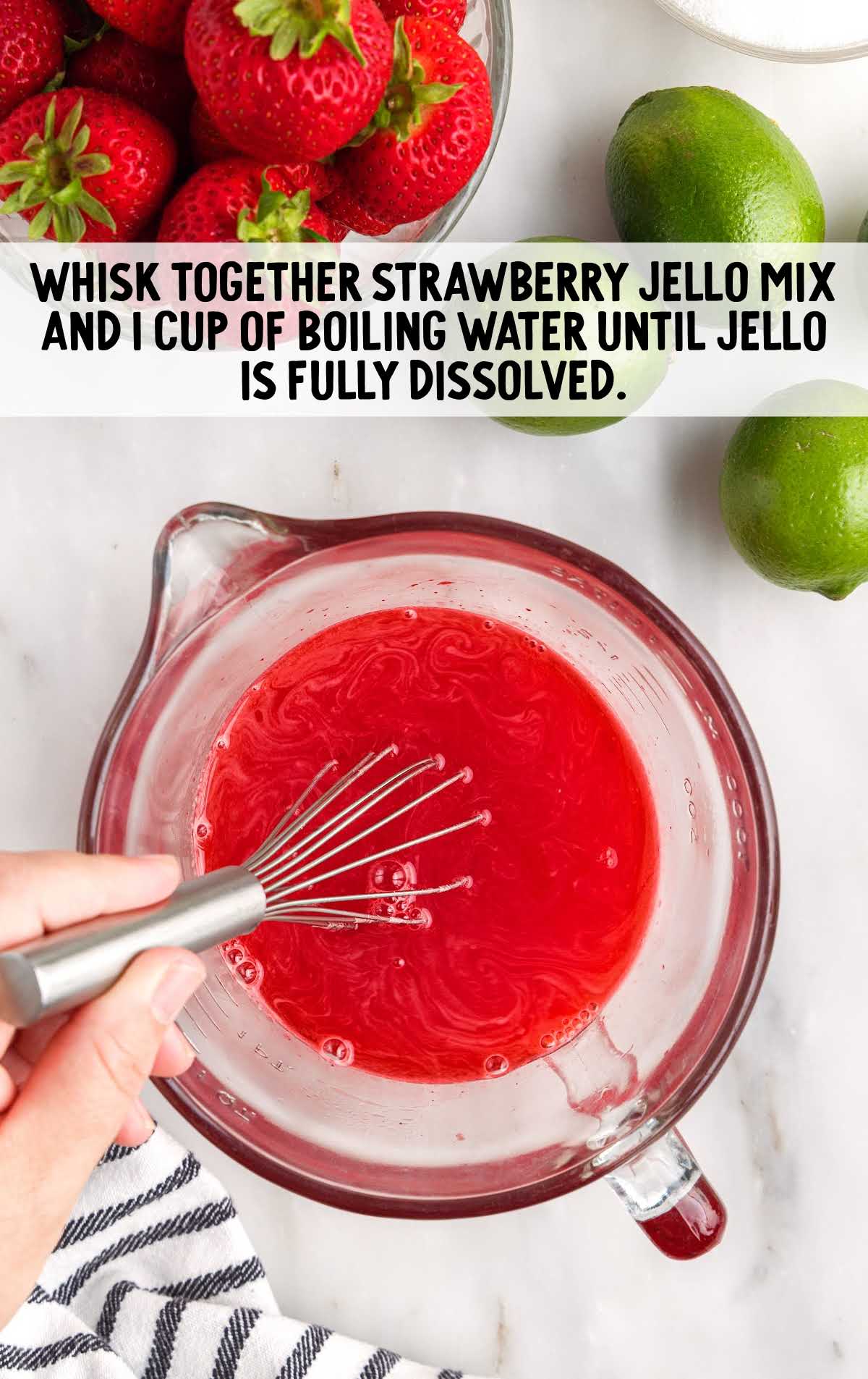 strawberry jello mix boiling water whisked in a pitcher