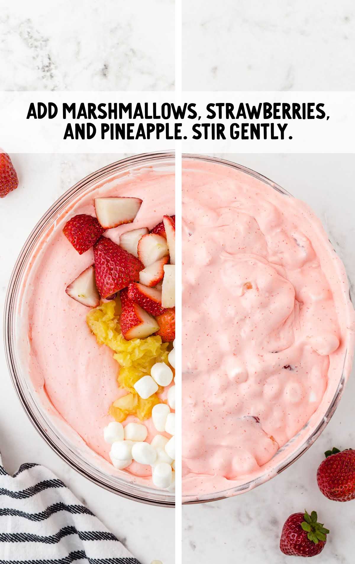 marshmallows, strawberries, and pineapples added to the whipped topping mixture in a bowl