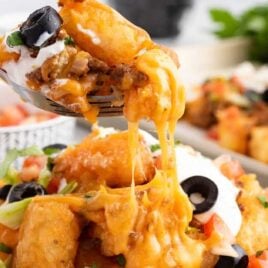 a close up shot of Tater Tot Nachos with a fork getting a piece