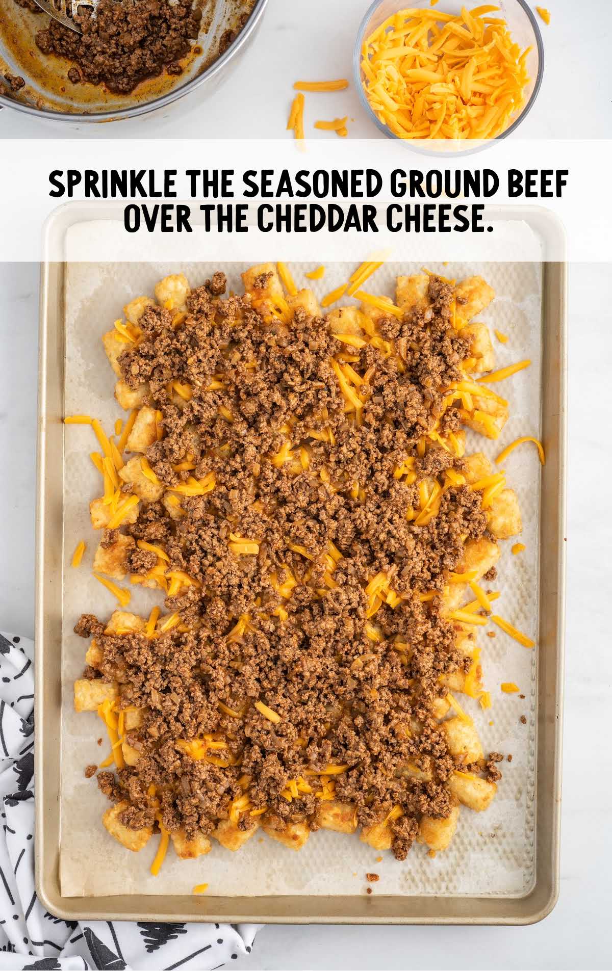 seasoned ground beef sprinkled over the cheddar cheese