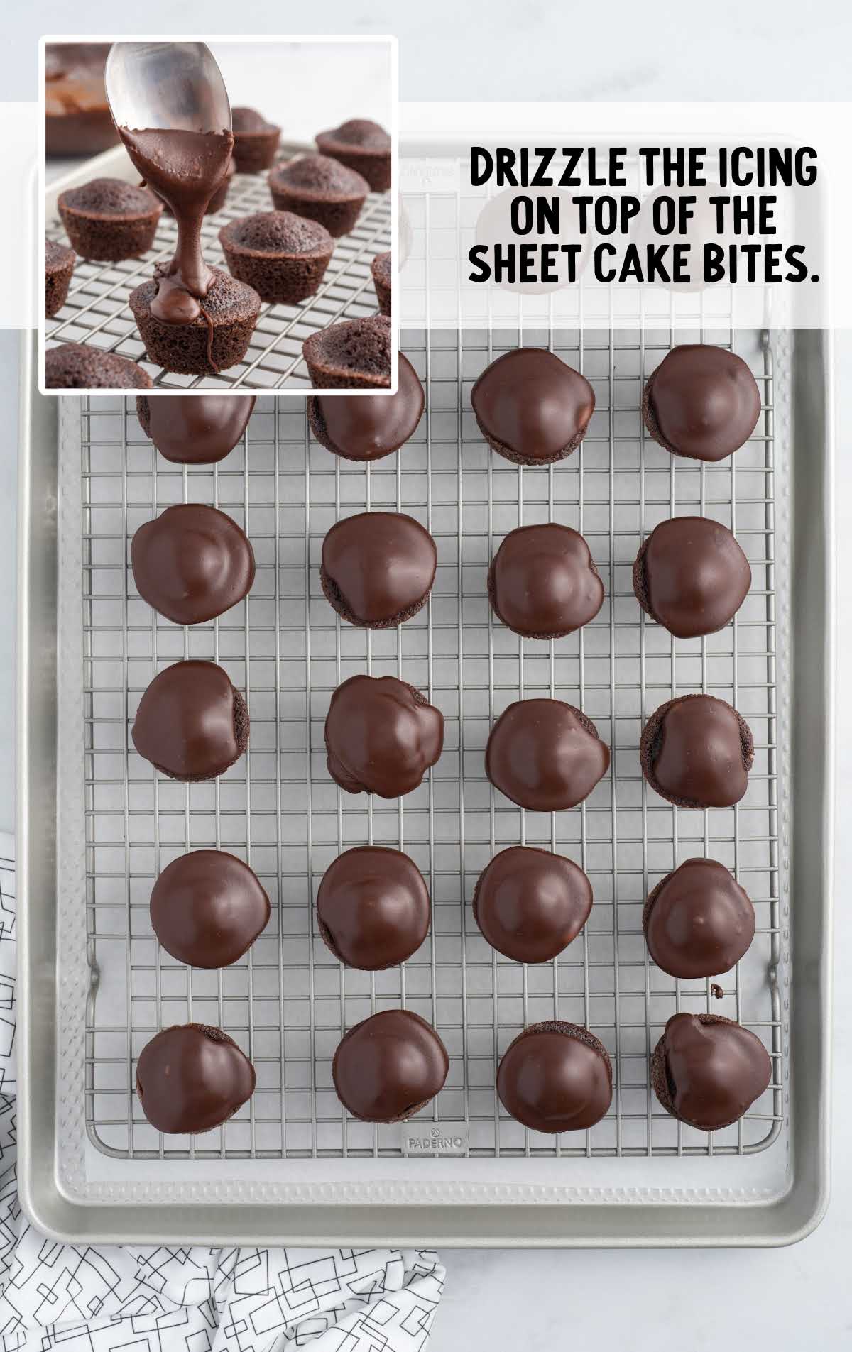 icing drizzled on top of the sheet cake bites on a cooling rack