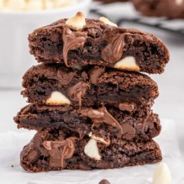 a close up shot of Triple Chocolate Cookies split in half and stacked on top of each other