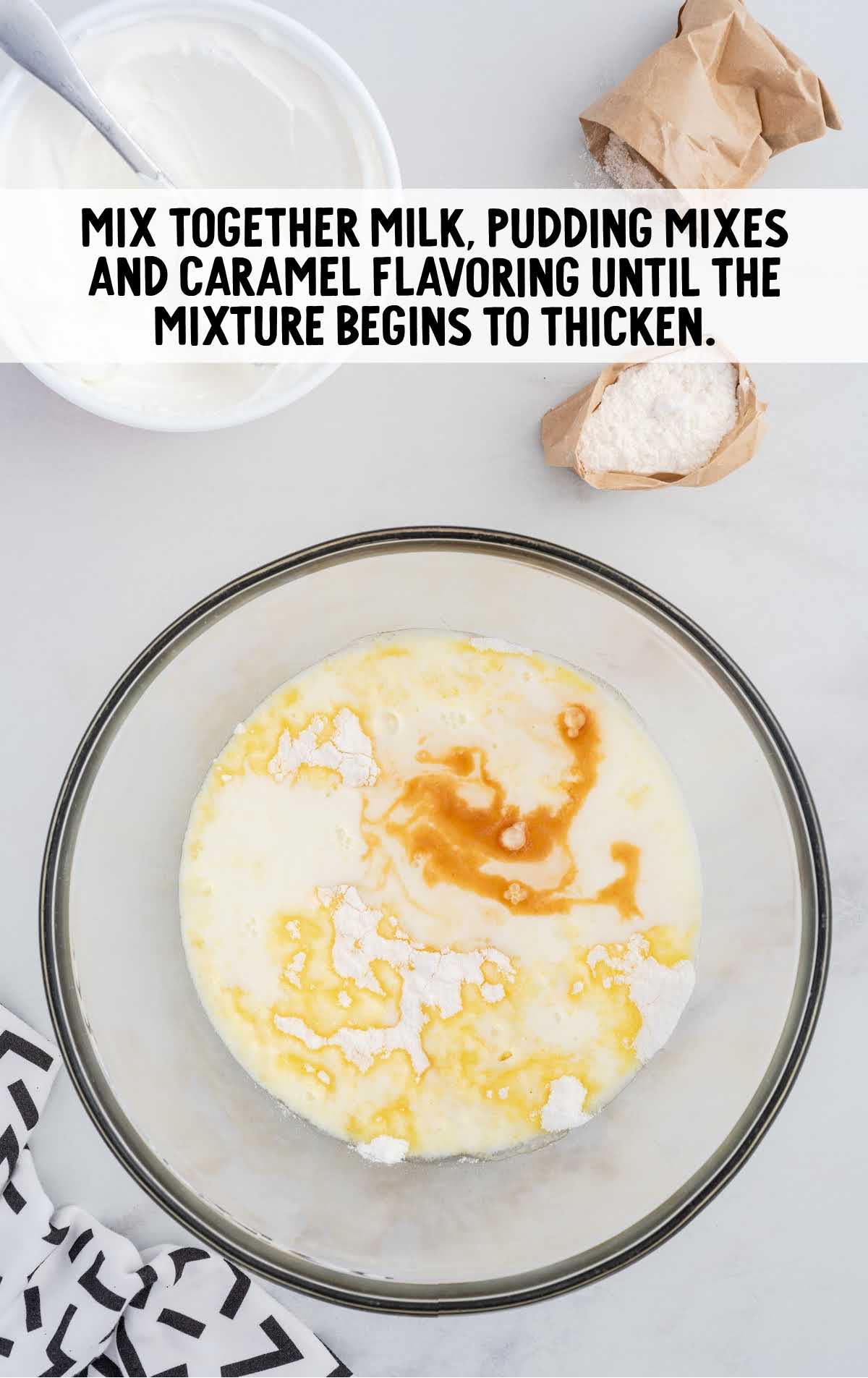 milk, pudding mixes and caramel mixed in a bowl