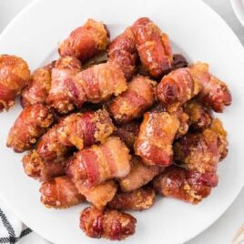 overhead shot of Bacon Wrapped Smokies staked on top of each other on a plate