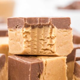 a close up shot of Buckeye Fudge stacked on top of each other with a bite taken out of it
