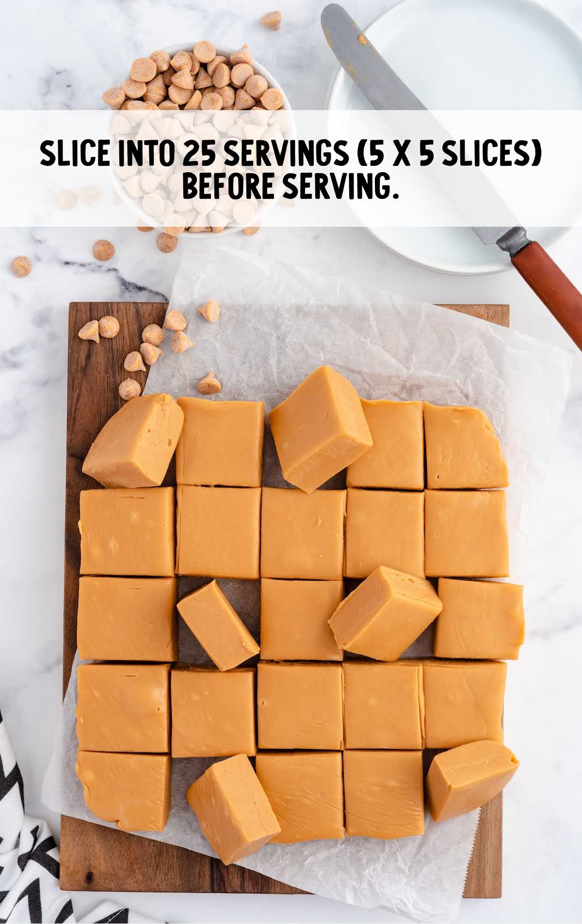 using a knife slice fudge blocks into 25 serving slices on a wooden board