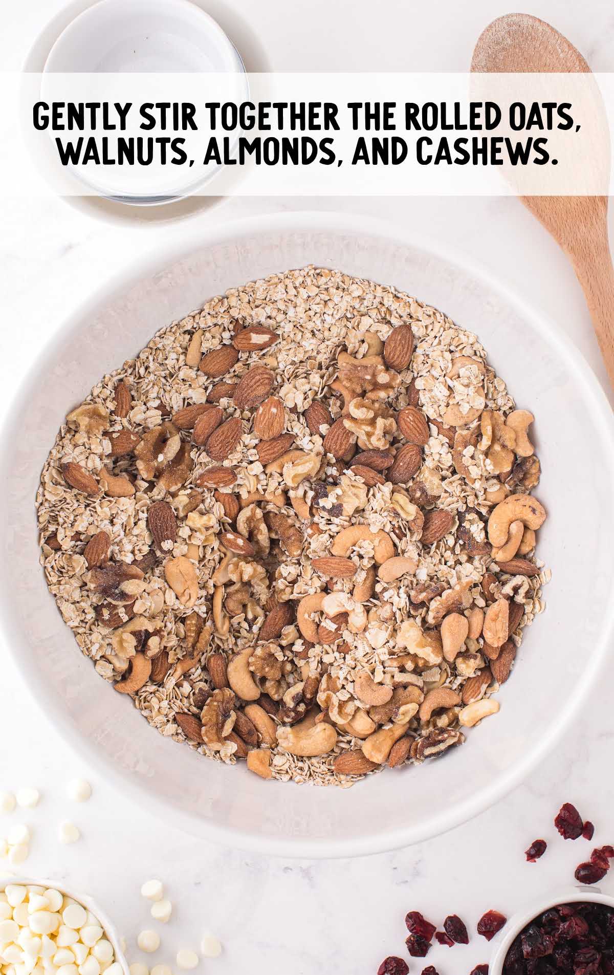 rolled oats, walnut, almond, and cashews stirred in a bowl