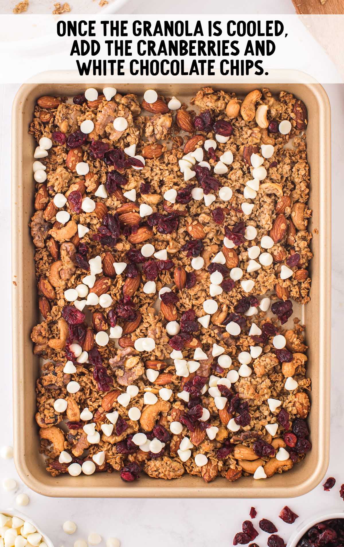 cranberries and white chocolate chips added on a sheet pan