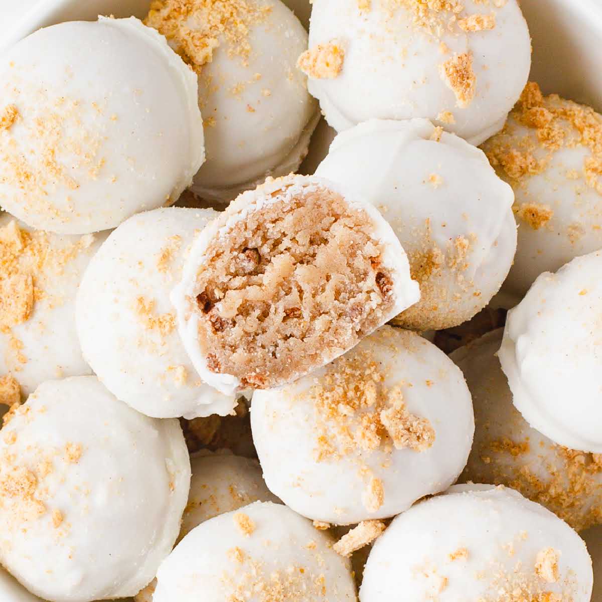 overhead shot of Cinnamon Toast Crunch Cheesecake Bites with one having a bite taken out of it