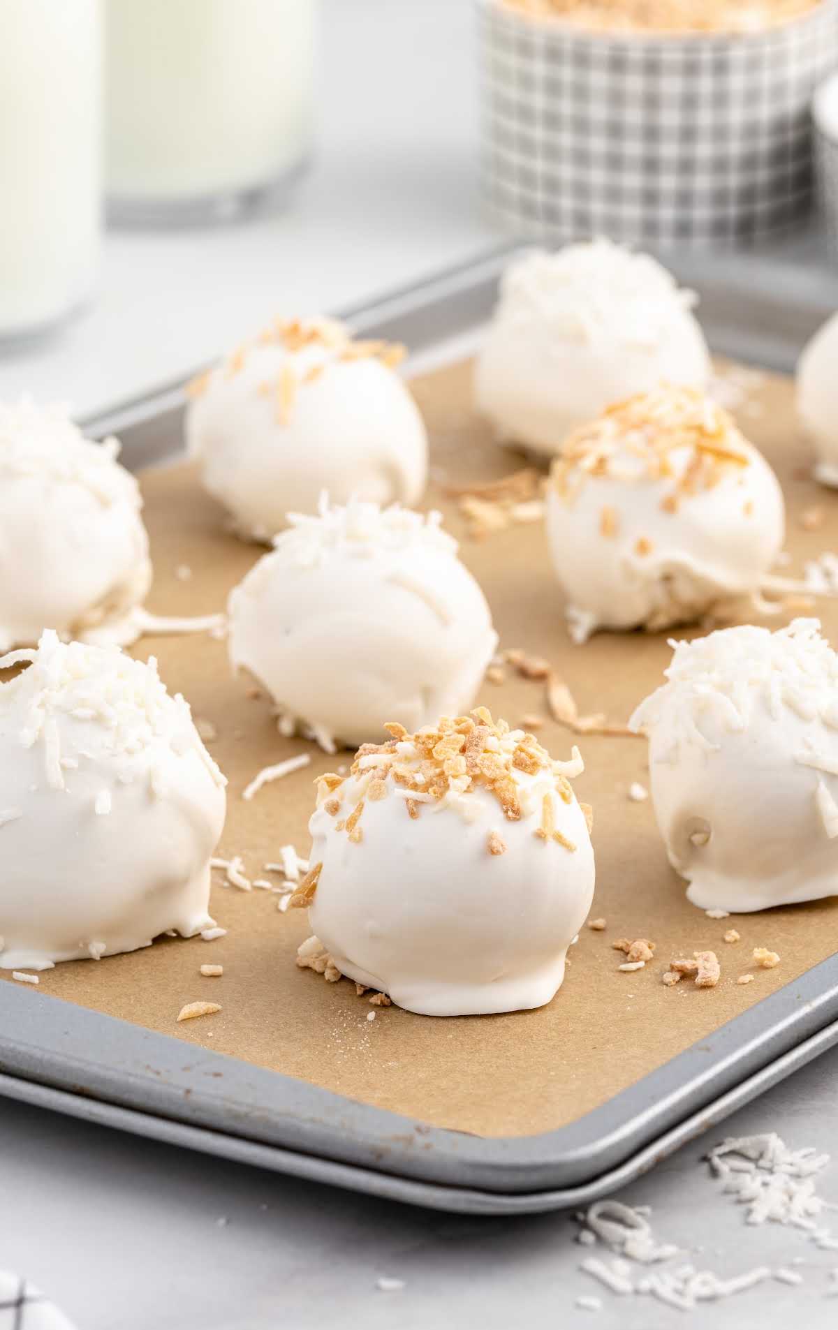 close up shot of Coconut Cheesecake Bites on a baking sheet