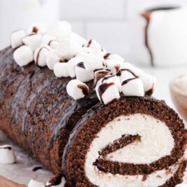 a close up shot of Hot Chocolate Roll Cake on a wooden board