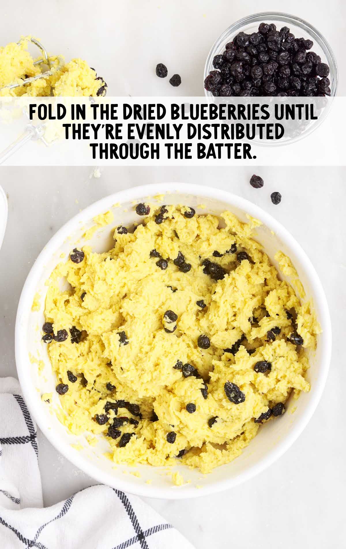 blueberries added to the cake mix and folded together in a bowl