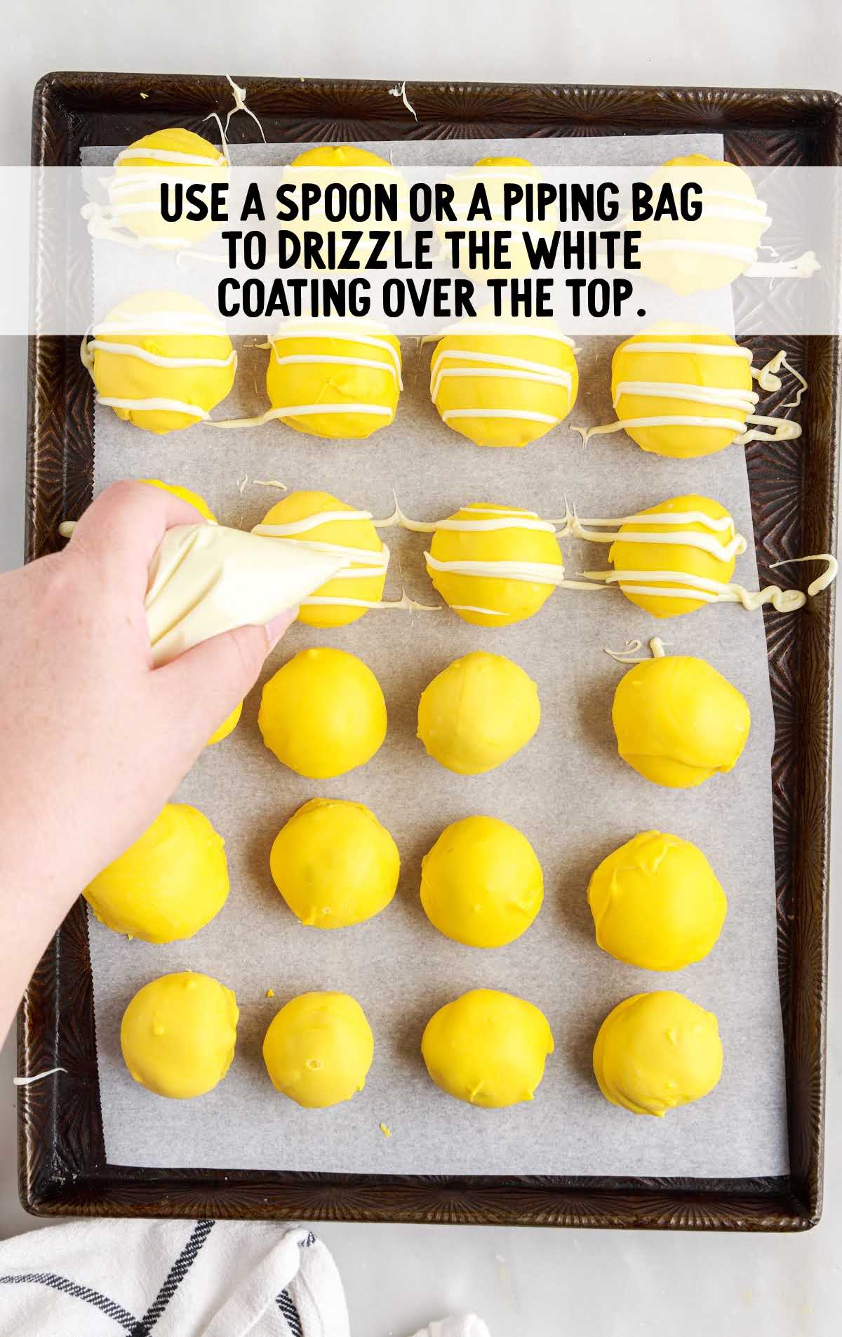 white coating drizzled on top of the bites in a baking sheet