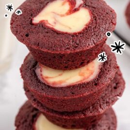 a close up shot of a couple of Mini Red Velvet Cheesecake stacked on top of each other