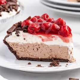 a close up shot of a slice of No Bake Black Forest Cheesecake on a plate