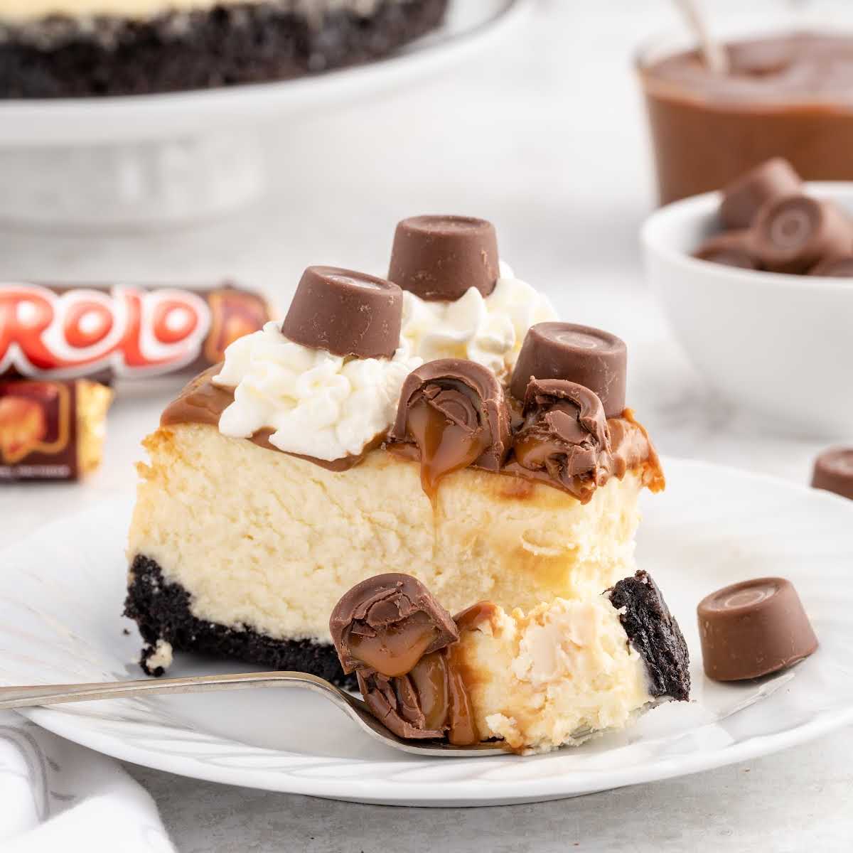 a slice of rolo cheesecake on a plate with a fork