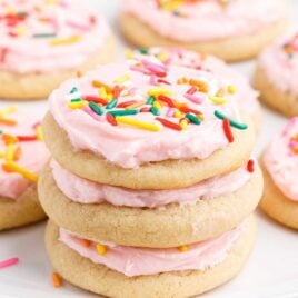 a close up shot of Soft Sugar Cookies stacked on top of each other.