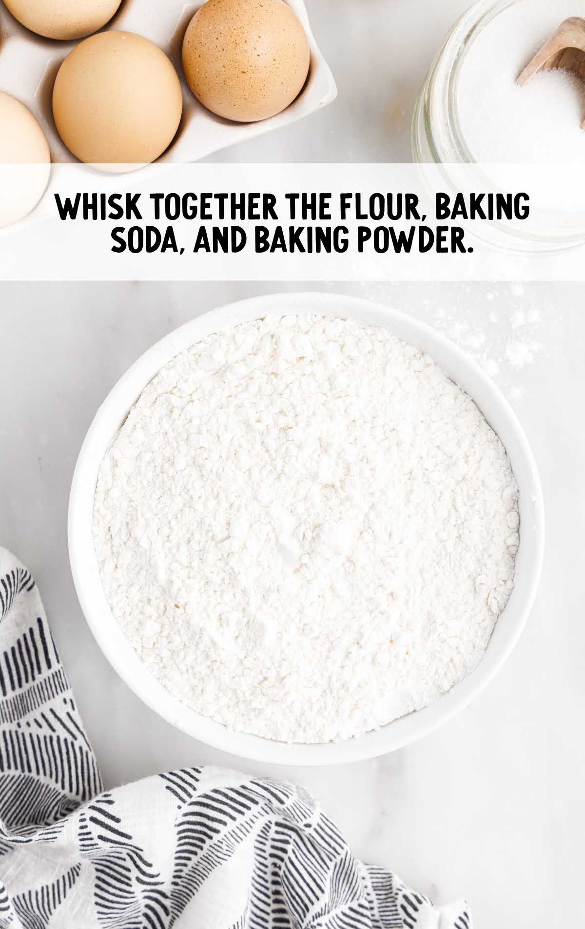 flour, baking soda, and baking powder whisked in a bowl