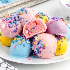 a close up shot of Unicorn Cheesecake Bites on a plate