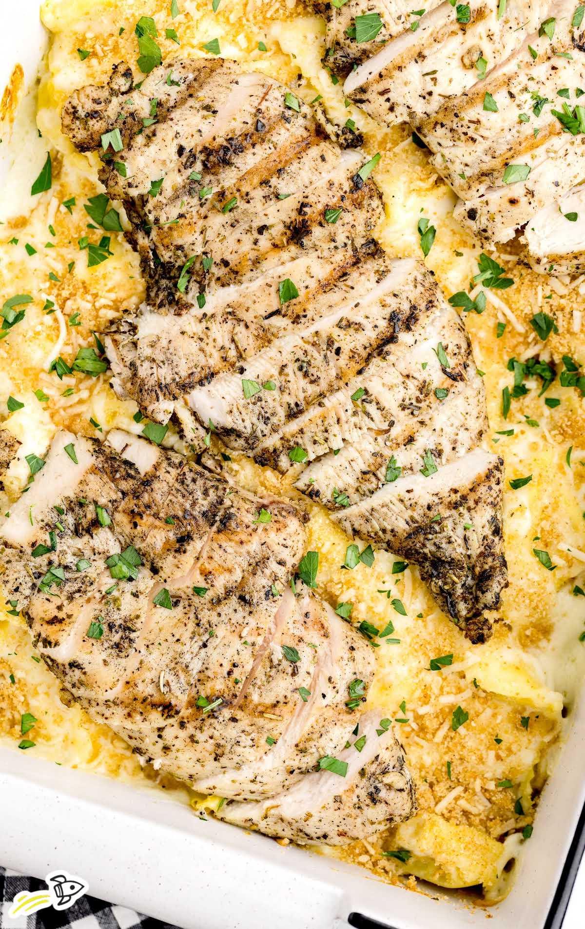a overhead shot of Asiago Tortellini Alfredo with Grilled Chicken on a baking dish