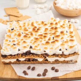 a close up shot of Baked S’mores on a wooden cutting board