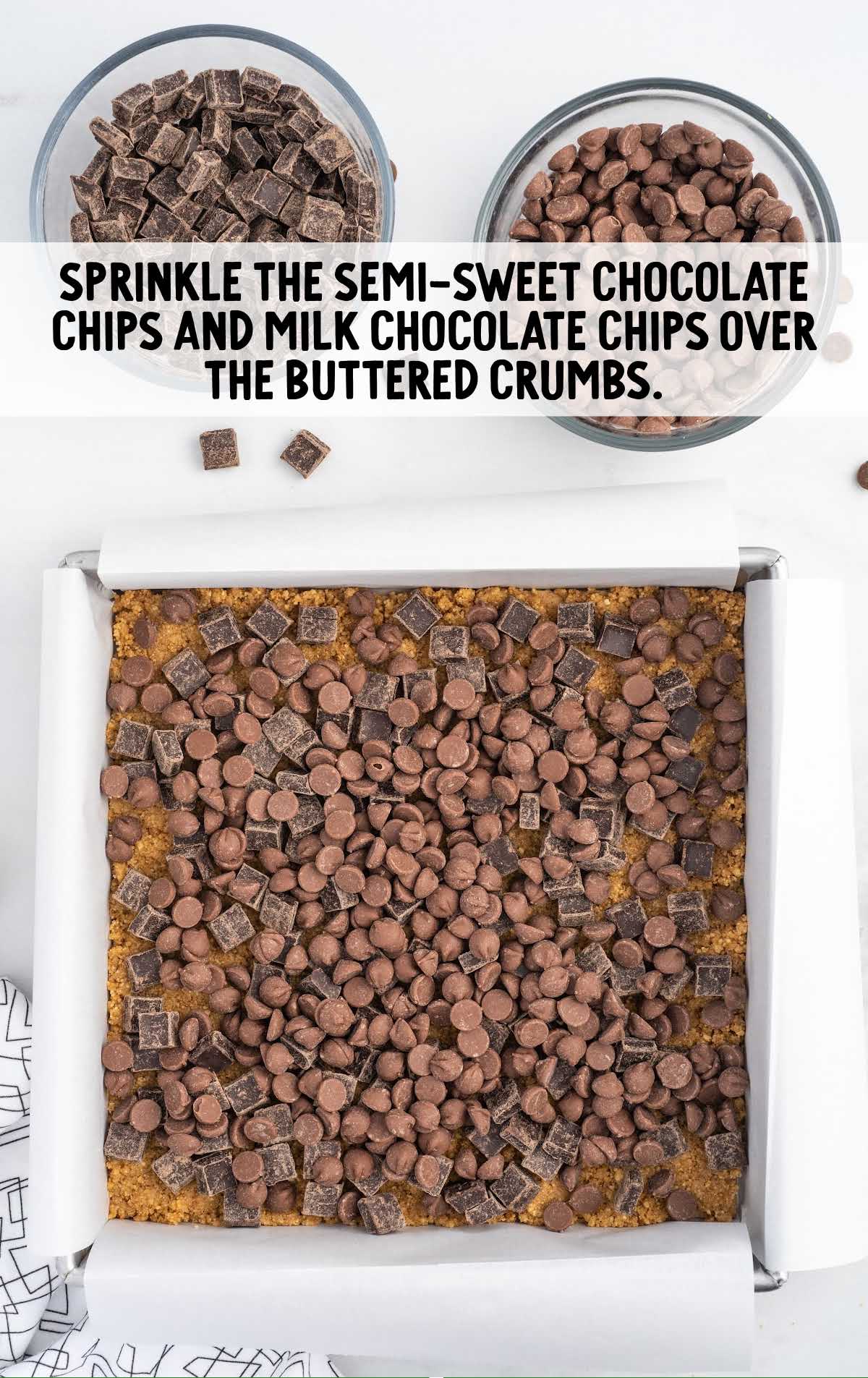 semi sweet chocolate chips and milk chocolate chip sprinkled over the buttered crumbs