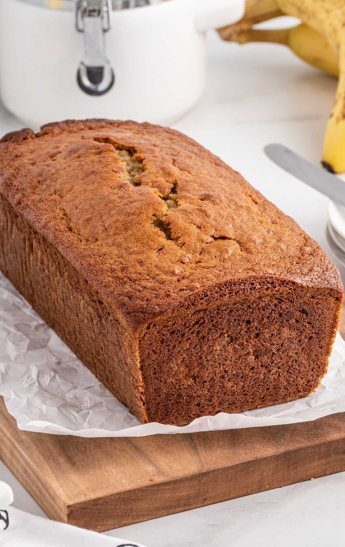 a close up shot of Banana Bread on a wooden cutting board