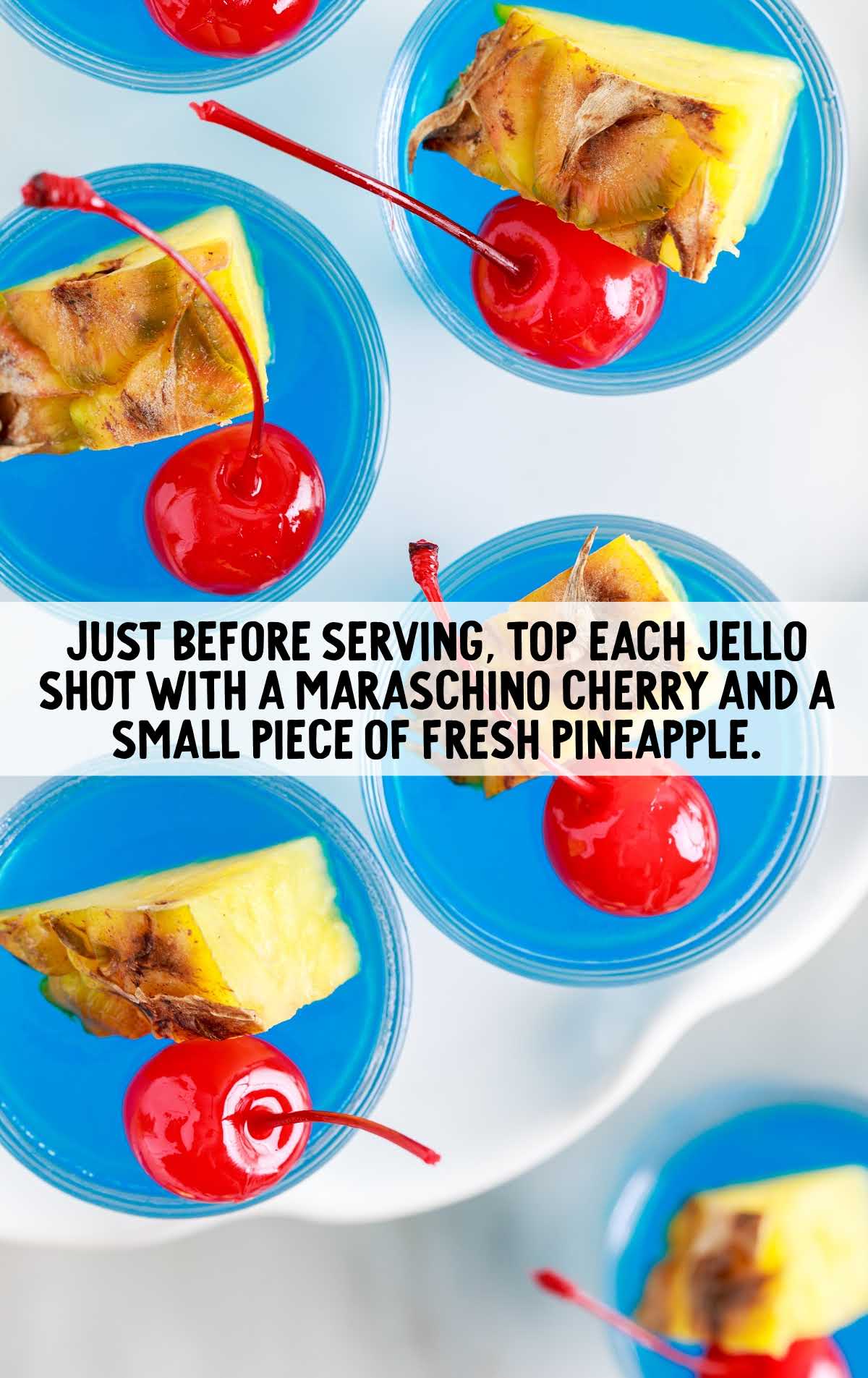 jello shot topped with cherry and sliced pineapple