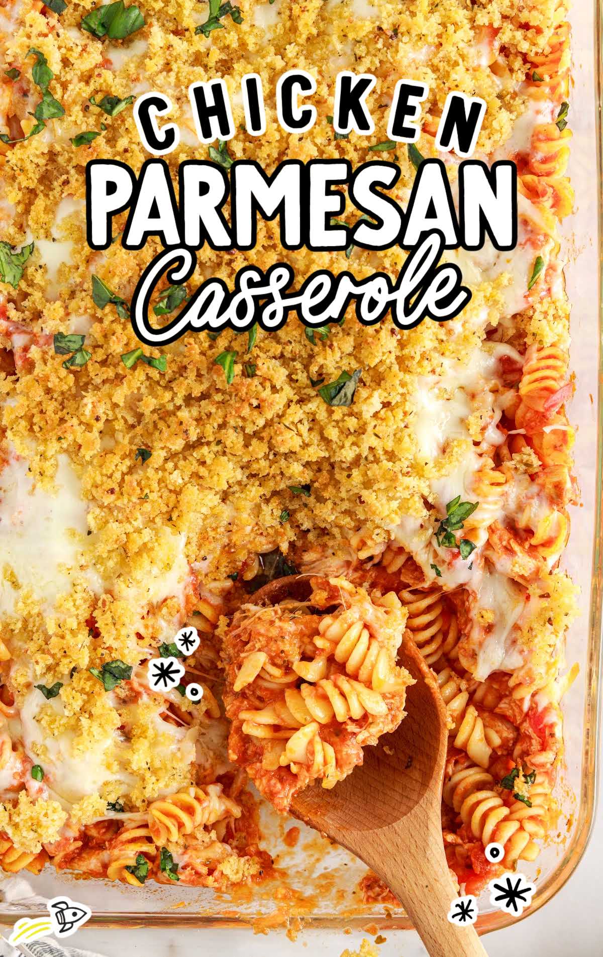overhead shot of Chicken Parmesan Casserole with a piece of taken out with a wooden soon