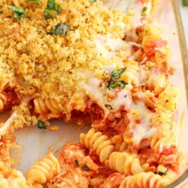 a close up shot of Chicken Parmesan Casserole with a piece of taken out